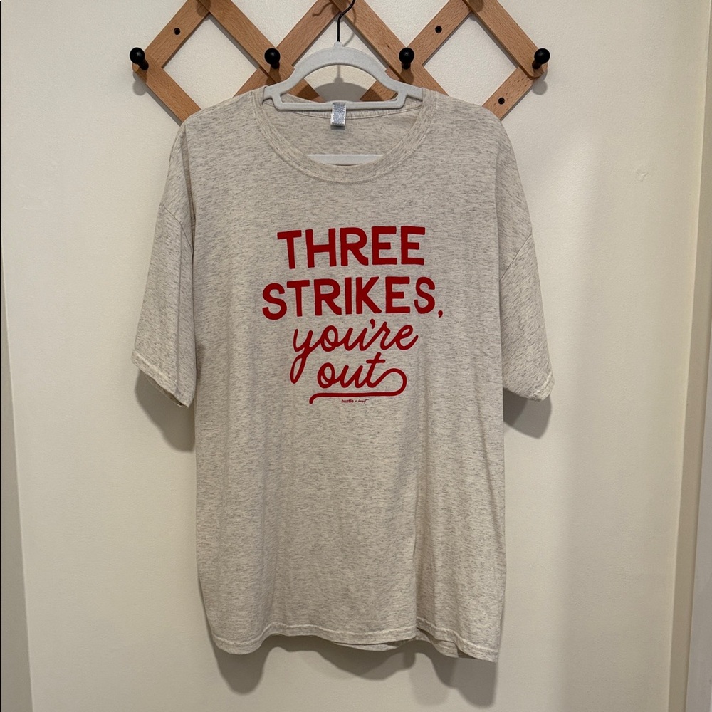 Hustler Hollywood Beige Tee with Red Text